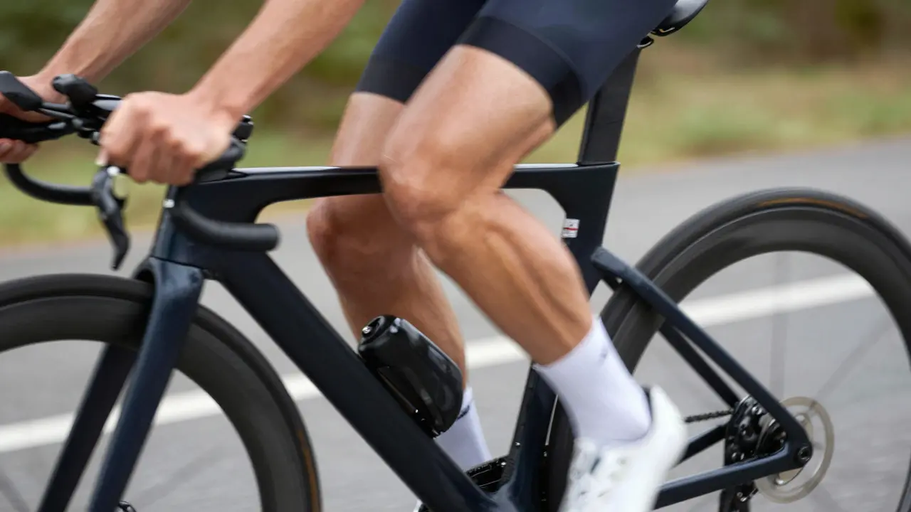 Cyclist's leg showing powerful muscle movement and biomechanical efficiency
